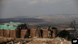 Turkish soldiers hold a position atop Bursayah Hill, Afrin region, March 3, 2018, during a Turkish government-organized media tour into northern Syria.