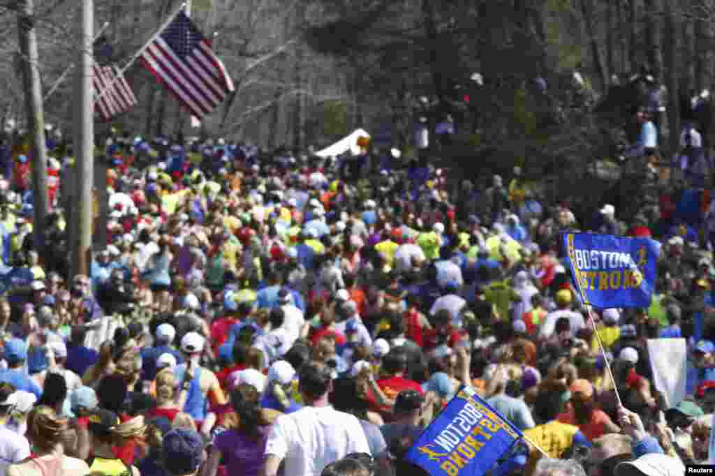 The second wave of runners make their way down Main Street during the 118th running of the Boston Marathon in Hopkinton, Mass., April 21, 2014.