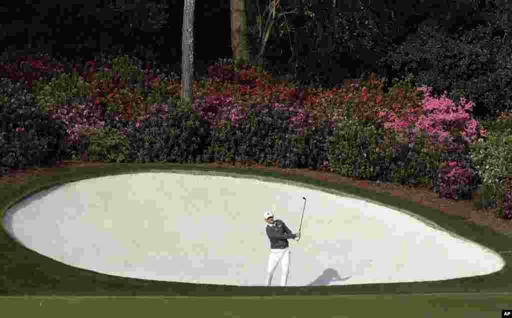 Brandt Snedeker hits out of a bunker on the 13th hole during a practice round for the Masters golf tournament in Augusta, Georgia, USA.