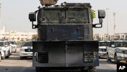 FILE - Police vehicles block the road to al-Ekr village, Bahrain, July 19, 2015. 