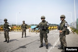 South Korean soldiers stand guard at checkpoint on Grand Unification Bridge which leads to truce village Panmunjom, just south of the demilitarized zone separating the two Koreas, in Paju, South Korea, Aug. 24, 2015.