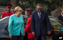 German Chancellor Angela Merkel, left, is welcomed by Ethiopia's Prime Minister Hailemariam Desalegn, as she arrives at the national palace in Addis Ababa, Ethiopia, Oct. 11, 2016.