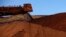 Major mining companies like Rio Tinto, unloading iron ore in Australiaa in December, 2013, will learn the true extent of Cameroon's resources after a World Bank-funded aerial survey of one of Africa's mineral-rich nation's. 