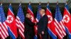 FILE - Kim Jong Un and President Donald Trump shake hands prior to their meeting in Singapore, June 12, 2018.