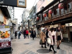 Residents walk down a street in Kyoto, Japan, one of the nations with the most physical assets, like buildings, at risk of climate disasters.