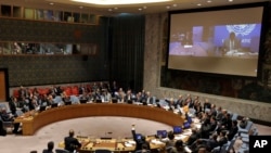 FILE - The U.N. Security Council votes on a resolution concerning Somalia, March 23, 2017. President Mohamed Abdullahi Mohamed addressed the council via a video link from Nairobi.