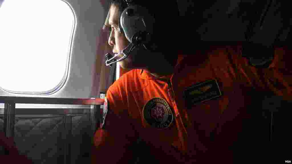 Indonesian Air Force CN 295 plane crew surveying the area from air in search of the bodies of AirAsia plane crash victims