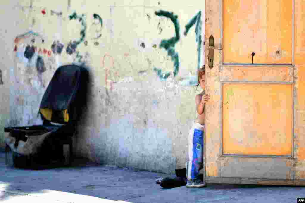 A girl, member of the Roma community, is pictured at the "River Village" Roma camp, managed by the Onlus Isola Verde association in Rome, Italy.