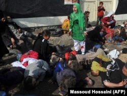 FILE -- Tarana Akbari, 12, screams in fear moments after a suicide bomber detonated a bomb in a crowd at the Abul Fazel Shrine in Kabul, Dec. 06, 2011. Photographer Massoud Hossaini won a Pulitzer Award for this photo in 2012.