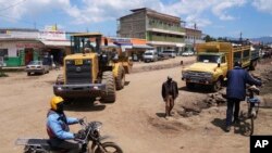 FILE - Construction vehicles are visible in Ndunyu Njeru, Kenya, January 25, 2024. After pressure from the Kenyan President, the environment authority has issued a license for the construction of a tarmac road through the Aberdare forest and mountain range to connect two counties