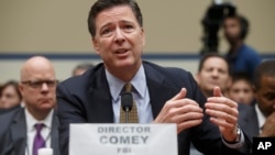 FILE - FBI Director James Comey testifies on Capitol Hill in Washington, July 7, 2016, before a House Committee to explain his agency's recommendation to not prosecute Hillary Clinton. On Friday, Comey said that new emails possibly related to the Clinton case have been unearthed.