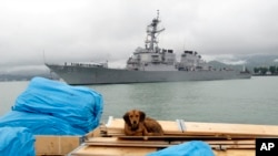 FILE - The U.S. guided missile destroyer USS Stout enters Georgia's Black Sea port of Batumi, July 14, 2009. An Iranian boat crossed in front of the Stout three times at high speed Wednesday in the Persian Gulf, U.S. officials said.