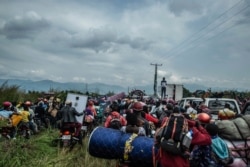 FILE - Residents flee Goma after the military governor of North Kivu province issued an evacuation order, May 27, 2021.