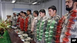 Newly graduated Afghan border police officers stand during a graduation ceremony at the border police headquarter in Jalalabad, Afghanistan, January 31, 2012.