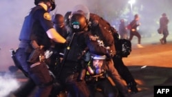 Four Portland police officers arrest a protester during a crowd dispersal near Mississippi Avenue on Aug. 14, 2020, in Portland, Oregon. 