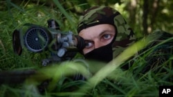 (FILE) A Russian sniper looks from his position toward Ukrainian positions in Ukraine.
