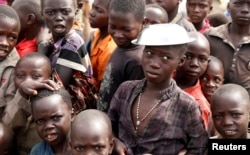 FILE - Children wait for food distribution at an internally displaced persons camp in Bunia, Ituri province, eastern Democratic Republic of Congo, April 12, 2018.