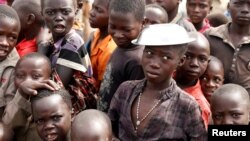 Children wait for food distribution at an internally displaced persons camp in Bunia, Ituri province, eastern Democratic Republic of Congo, April 12, 2018. 