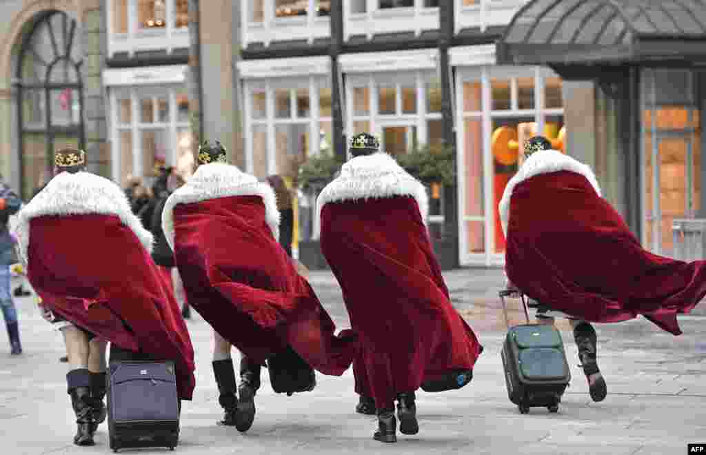 Four men dressed as kings arrive at the city center where tens of thousands revelers will celebrate the start of the street-carnival in Cologne, Germany.