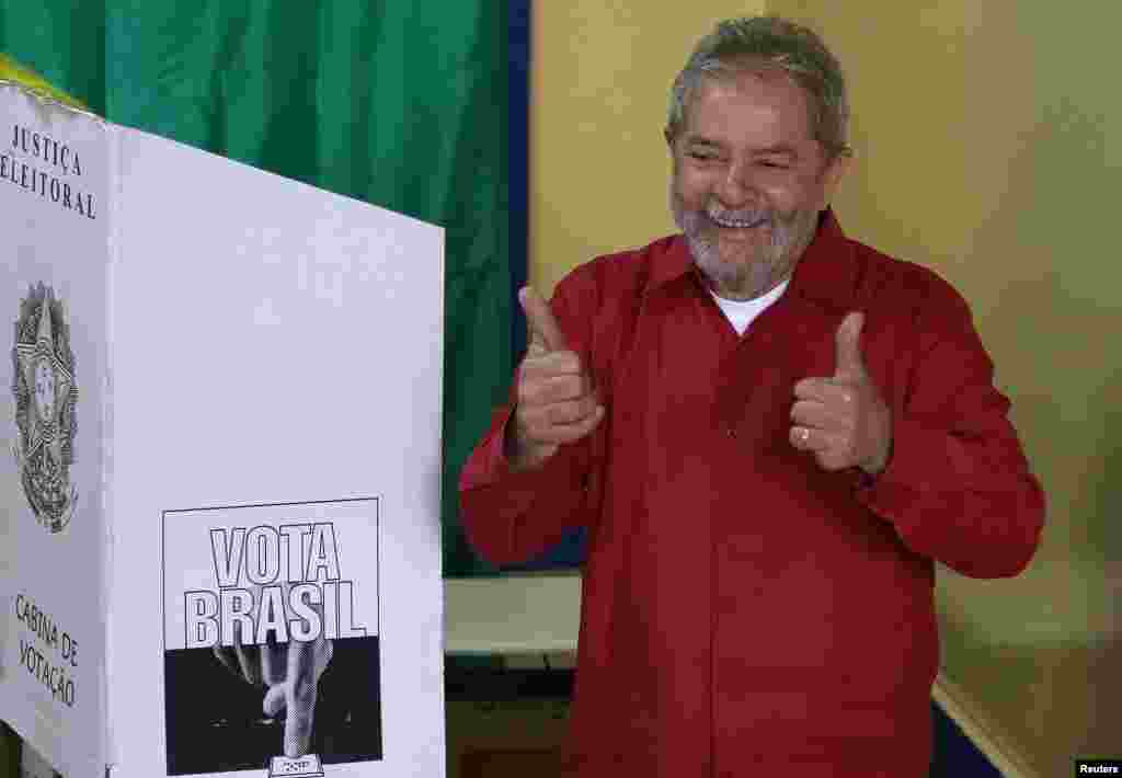 Brazil's former President Luiz Inacio Lula da Silva gives a thumbs-up after casting his vote during presidential elections, in his hometown city of Sao Bernardo do Campo, Oct. 5, 2014.