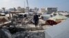 Palestinian man who lost his wife, children and grandchildren in an Israeli strike, walks in Rafah