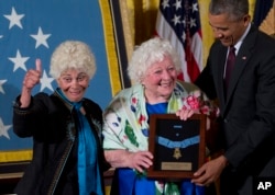 President Barack Obama posthumously bestows the Medal Of Honor for Army Sgt. William Shemin to his daughters Ina Bass, left, and Elsie Shemin-Roth, of suburban St. Louis, in the East Room of the White House in Washington, June 2, 2015.