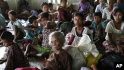 Local residents take refuge in a monastery compound in Sittwe, the capital of Rakhine state in western Myanmar, where sectarian violence continues to impact the public, Wednesday, June 13, 2012. Heavy rain Wednesday brought an uneasy calm to western Myanm