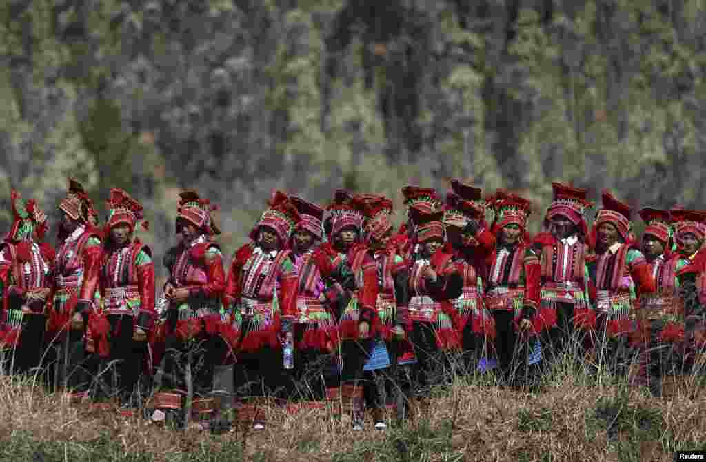 Ethnic Yi women are seen on their way to a dragon worship ceremony in Shiping county, Yunnan province. The dragon worship ceremony is held every 12 years to pray for good fortune and harvest.