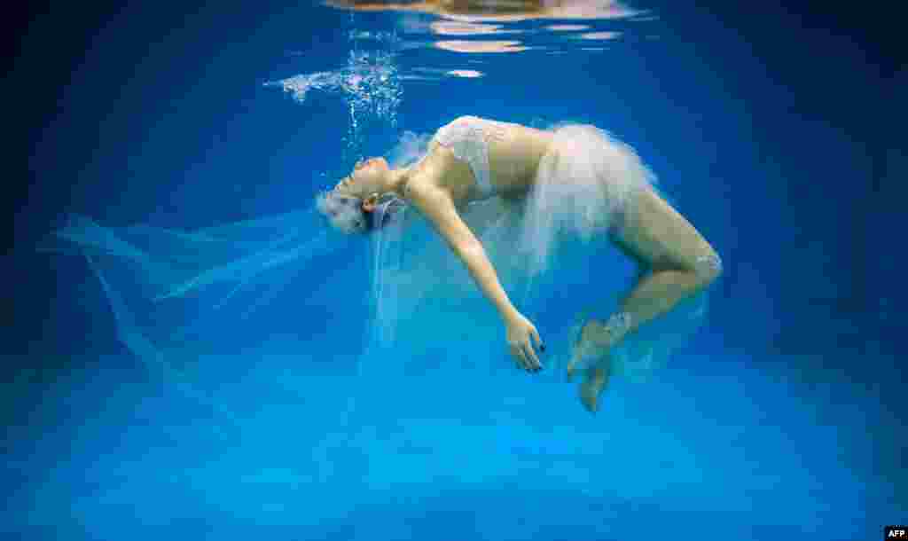 Leng Yuting, 26, poses underwater for her wedding pictures at a photo studio in Shanghai, China, ahead of her wedding next year.