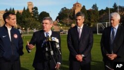 FILE - International Olympic Committee President Thomas Bach, second from left, is flanked by Los Angeles Mayor Eric Garcetti, left, LA 2024 chairman Casey Wasserman, second from right, and UCLA chancellor Gene Block, right, during a news conference in Los Angeles, Feb. 1, 2016.