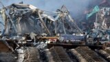 Charred remains of a warehouse and what were new cars after an explosion at a warehouse in northeastern China&#39;s Tianjin municipality, Thursday, Aug. 13, 2015.