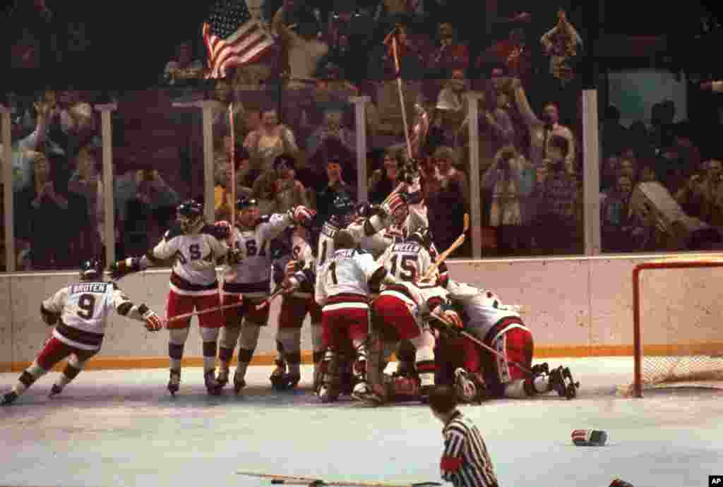 The U.S. hockey team pounces on goalie Jim Craig after a 4-3 victory against the Soviets in the 1980 Olympics, as a flag waves from the partisan Lake Placid, N.Y. crowd. The team from the Soviet Union was the dominant international team in the sport. The U.S. went on to win the Olympic gold medal by defeating Finland.