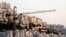 FILE - A crane is seen next to homes in the Har Homa Jewish settlement in Jerusalem.
