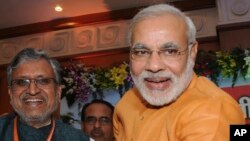 Chief Minister of India’s western state of Gujarat Narendra Modi, right, stands with Bihar state Deputy Chief Minister Sushil Modi, June 9, 2013.