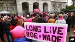 FILE - Pat Thompson displayed a sign supporting Roe v. Wade at a rally, held by Planned Parenthood, commemorating the 45th anniversary of the landmark Supreme Court decision at the Capitol, Jan. 22, 2018, in Sacramento, California. 