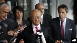 Director General of the International Atomic Energy Agency, IAEA, Yukiya Amano, center, speaks to the media after returning from Iran at the Vienna International Airport, Austria, May 22, 2012. 