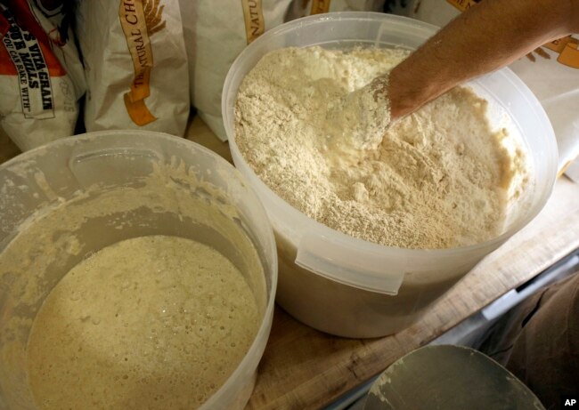 In this Sept. 10, 2015 photo, Chad Robertson, co-owner of Tartine Bakery, makes sourdough bread in the kitchen at Tartine in San Francisco. (AP Photo/Jeff Chiu)