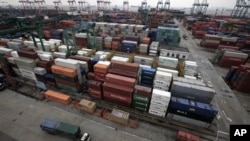 In this file photo, hundreds of shipping containers in Shanghai filled with products wait to be exported to the United States and other countries.