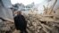A man inspects a damaged building after an earthquake at Dahejia in Jishishan County in northwest China's Gansu province on Dec. 20, 2023.