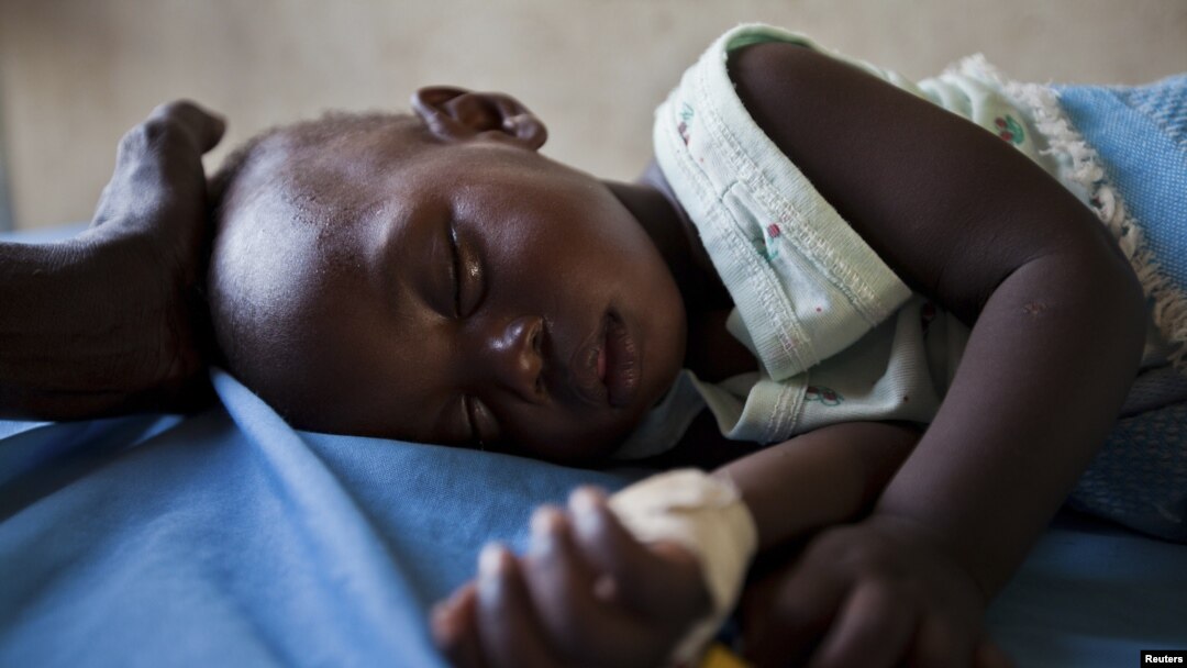 FILE - A young girl with malaria rests in the inpatient ward of the Malualkon Primary Health Care Center in Malualkon, in the South Sudanese state of Northern Bahr el-Ghazal, June 1, 2012. 