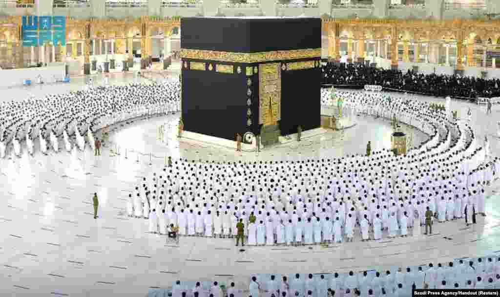 Pilgrims perform the Fajr prayer without social distancing, after Saudi authorities announced the easing of coronavirus disease restrictions, at the Grand Mosque in holy city of Mecca, Saudi Arabia.