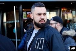 Eric Drouet, a prominent and divisive figure of the yellow vest movement, walks out of the Court after his trial for organizing an unauthorized demonstration, in Paris, Friday, Feb. 15, 2019.