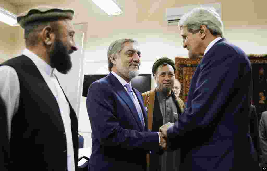 Afghan presidential candidate Abdullah Abdullah, center, shakes hands with U.S. Secretary of State John Kerry at the start of a meeting at the U.S. Embassy in Kabul, July 11, 2014.