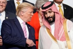 FILE - U.S. President Donald Trump speaks with Saudi Arabia's Crown Prince Mohammed bin Salman during a photo session with other leaders and attendees at the G-20 summit in Osaka, Japan, June 28, 2019.