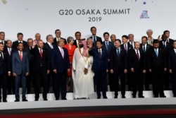 President Donald Trump and other leaders gather for a group photo at the G-20 summit in Osaka, Japan, June 28, 2019.