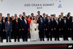 President Donald Trump and other leaders gather for a group photo at the G-20 summit in Osaka, Japan, June 28, 2019.