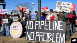 FILE - Demonstrators opposing the Keystone XL oil pipeline hold banners in Omaha, Neb., Jan. 13, 2015. 