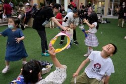 Children play on Children's Day at a mall in Beijing on June 1, 2021.