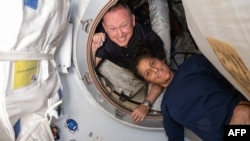 FILE - This undated picture from NASA released on July 2, 2024, shows astronauts Butch Wilmore and Suni Williams after they arrived at the International Space Station. The two have been in space weeks longer than planned because of mechanical issues.