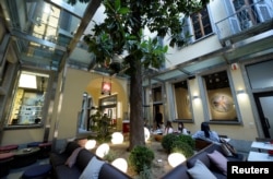 Guests are seen inside the Italian coffee roasting company illy Caffe's flagship store in downtown Milan, Italy. Sept. 15 2017.